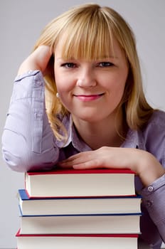 Young attractive happy woman with books