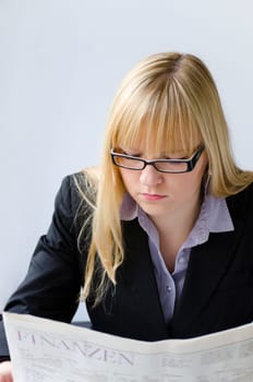Young woman reading important news in a newspaper