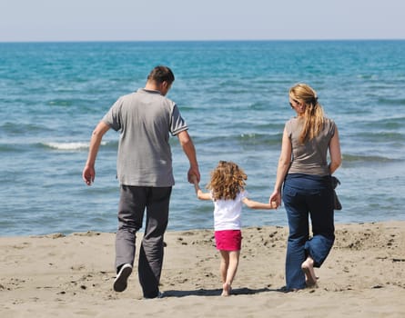 happy young family have fun and live healthy lifestyle on beach
