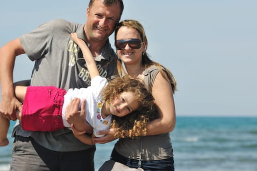 happy young family have fun and live healthy lifestyle on beach