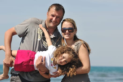 happy young family have fun and live healthy lifestyle on beach