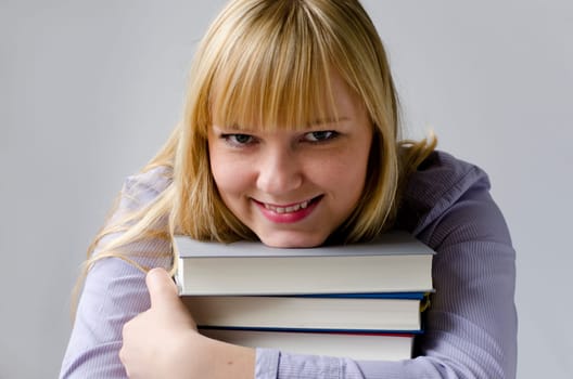 Young attractive happy woman with books