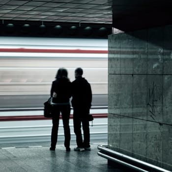subway station with couple and arrival train