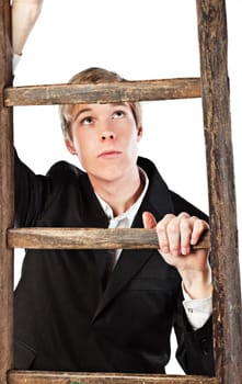 Young blond handsome man climbing wooden ladder