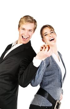 Young happy couple standing back to back and holding an orange together   isolated on white