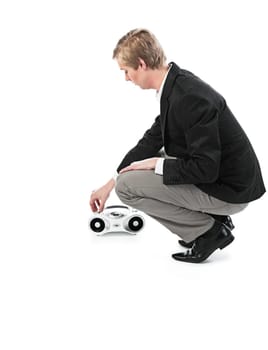 Young blond handsome man changing sound volume at boombox  isolated on white
