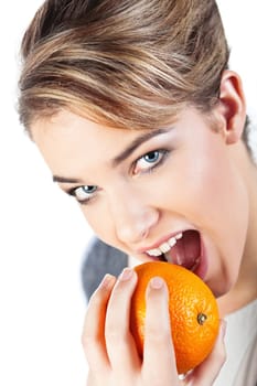 Portrait of pretty smiling young blond woman holding an orange  isolated on white