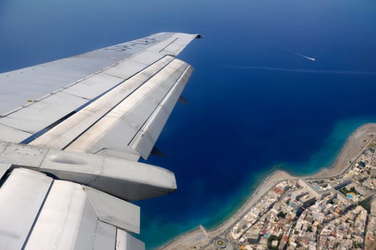 Sky, sea and island seen through window of an aircraft