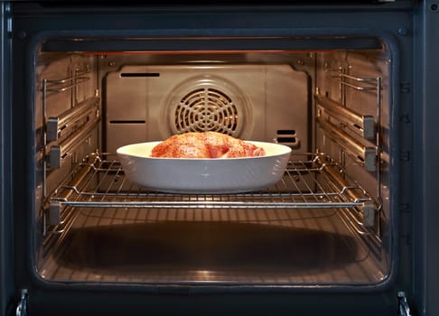 Baked chicken in open oven