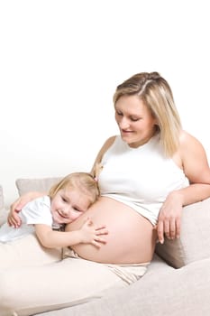 the little girl hugging his mother belly