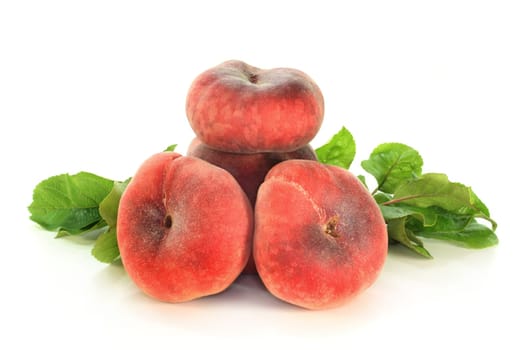 Mountain peaches and leaves against white background