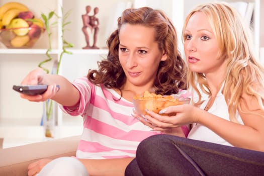 two women watching television in living room