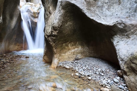 a beautiful waterfall among large stones, Sugaului Gorge, Bicaz, Romania