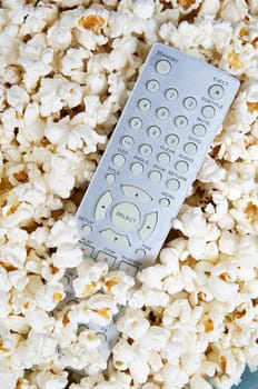 Popcorn and remote control prepared to see cinema