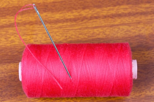 Detail of a needle with thread in a coil