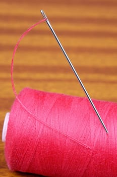 Detail of a needle with thread in a coil
