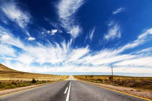 Endless,lonely road or highway that runs towards the horizon.