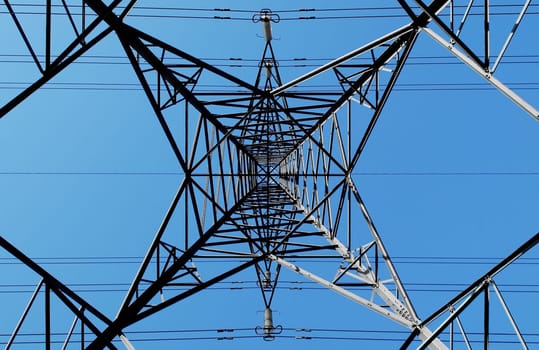 electricity pylon abstract against a blue sky