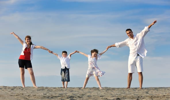 happy young family have fun and live healthy lifestyle on beach