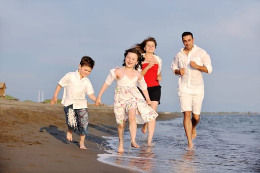 happy young family have fun and live healthy lifestyle on beach