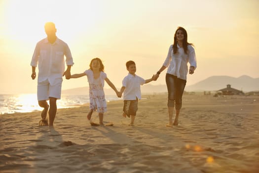 happy young family have fun and live healthy lifestyle on beach