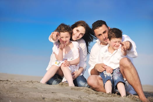happy young family have fun and live healthy lifestyle on beach