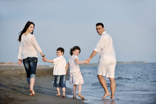 happy young family have fun and live healthy lifestyle on beach