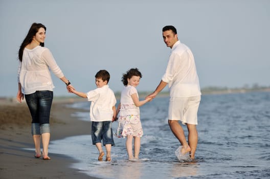 happy young family have fun and live healthy lifestyle on beach
