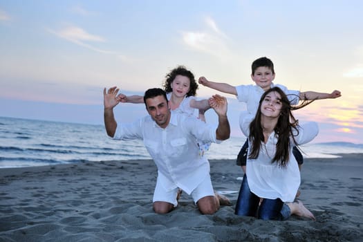 happy young family have fun and live healthy lifestyle on beach