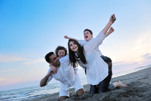 happy young family have fun and live healthy lifestyle on beach