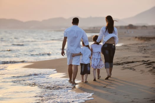 happy young family have fun and live healthy lifestyle on beach