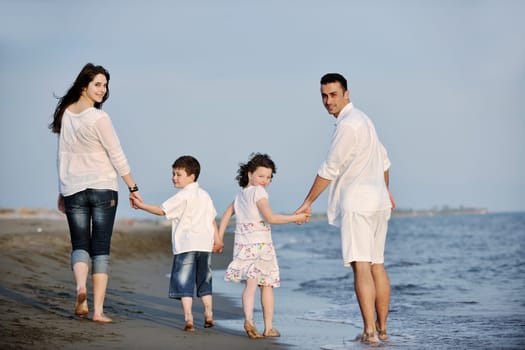 happy young family have fun and live healthy lifestyle on beach