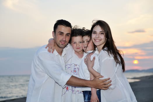 happy young family have fun and live healthy lifestyle on beach