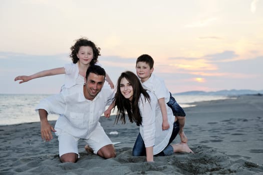 happy young family have fun and live healthy lifestyle on beach