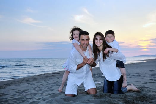happy young family have fun and live healthy lifestyle on beach