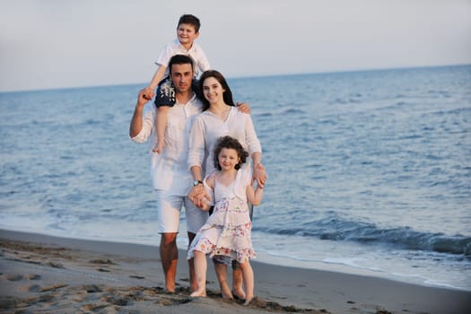 happy young family have fun and live healthy lifestyle on beach