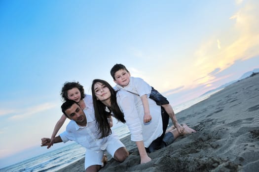 happy young family have fun and live healthy lifestyle on beach