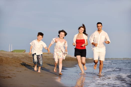 happy young family have fun and live healthy lifestyle on beach