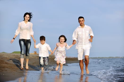 happy young family have fun and live healthy lifestyle on beach