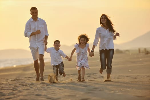 happy young family have fun and live healthy lifestyle on beach