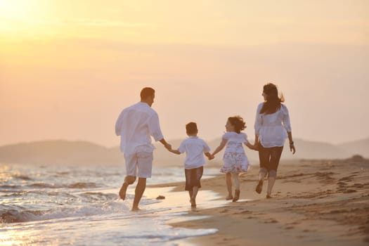 happy young family have fun and live healthy lifestyle on beach