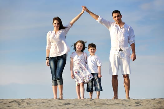 happy young family have fun and live healthy lifestyle on beach
