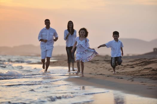 happy young family have fun and live healthy lifestyle on beach