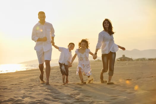 happy young family have fun and live healthy lifestyle on beach