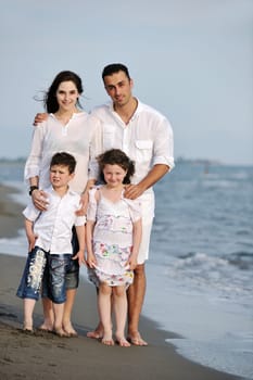happy young family have fun and live healthy lifestyle on beach