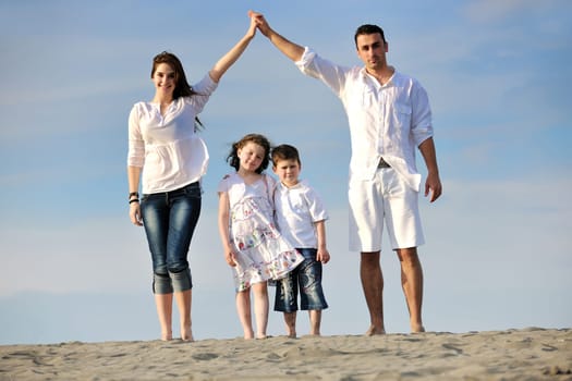 happy young family have fun and live healthy lifestyle on beach