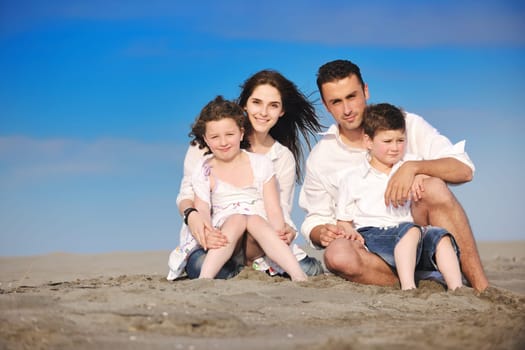 happy young family have fun and live healthy lifestyle on beach