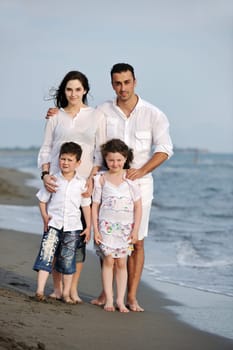 happy young family have fun and live healthy lifestyle on beach