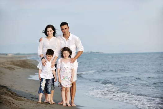 happy young family have fun and live healthy lifestyle on beach