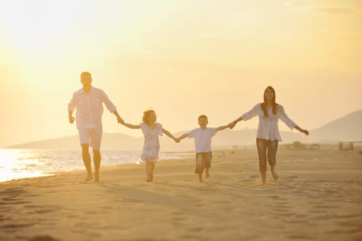 happy young family have fun and live healthy lifestyle on beach